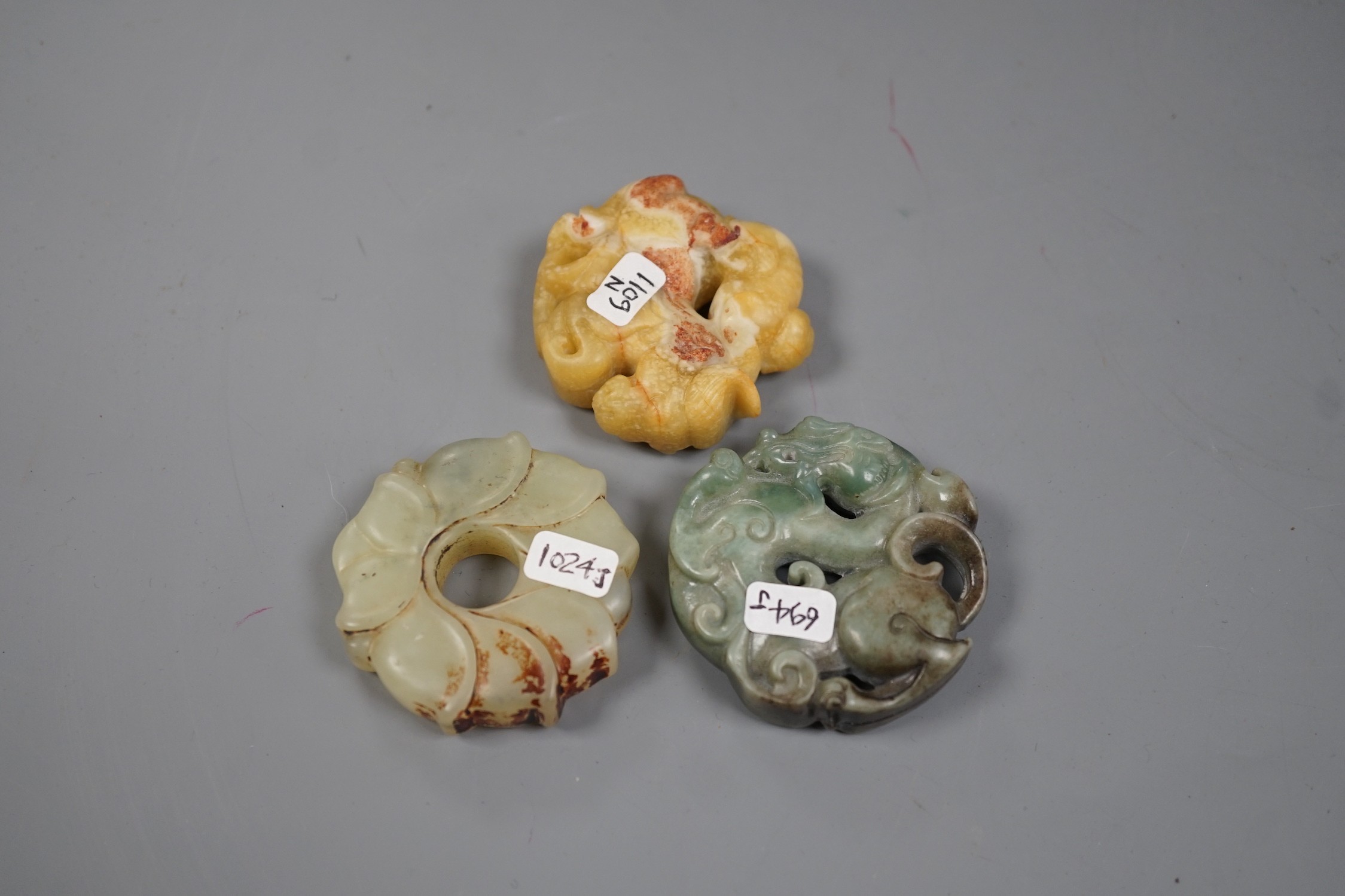 Three Chinese russet jade or hardstone bi discs